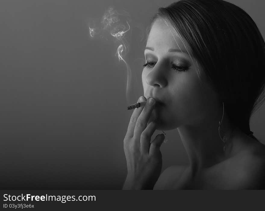 Beautiful young woman smoking a cigarette