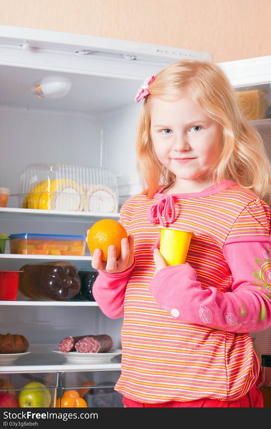 Girl with food on background fridge. Girl with food on background fridge