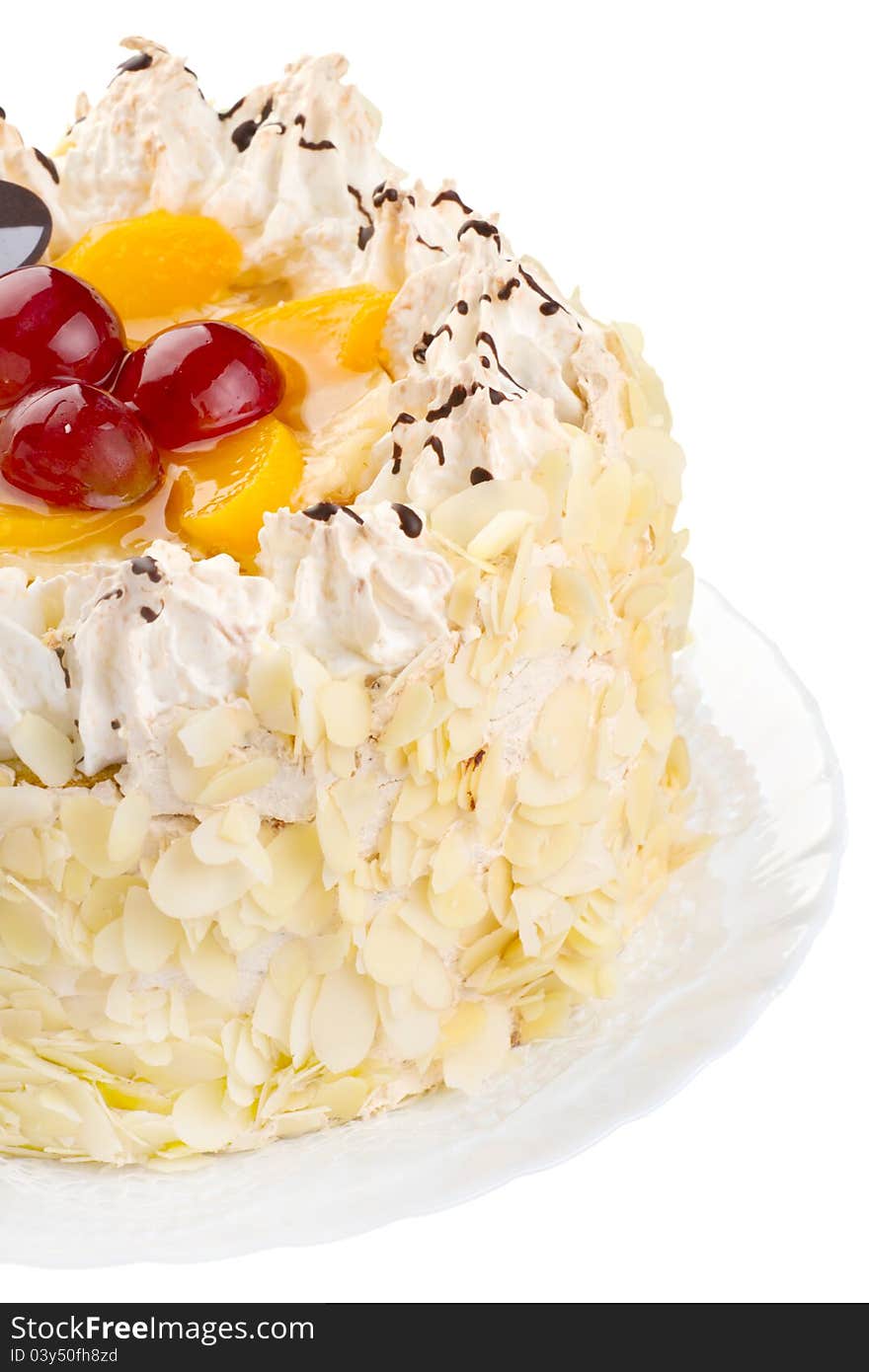 Close-up of a creamy cake with fruits and almonds