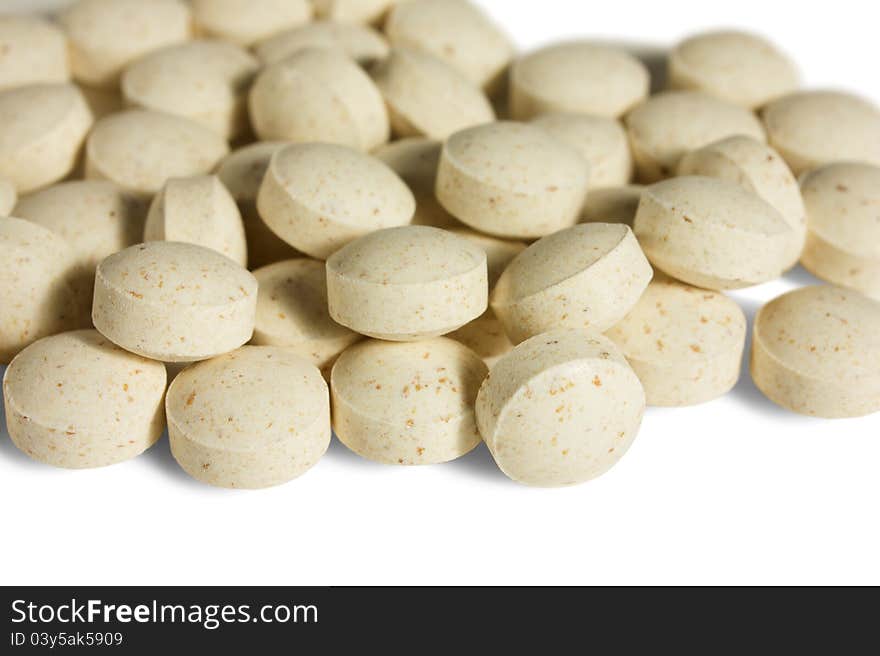 Multivitamins round tablets on white background