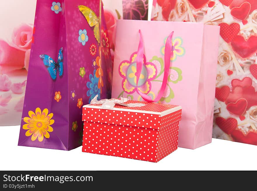 Decorative bags with gifts isolated on white