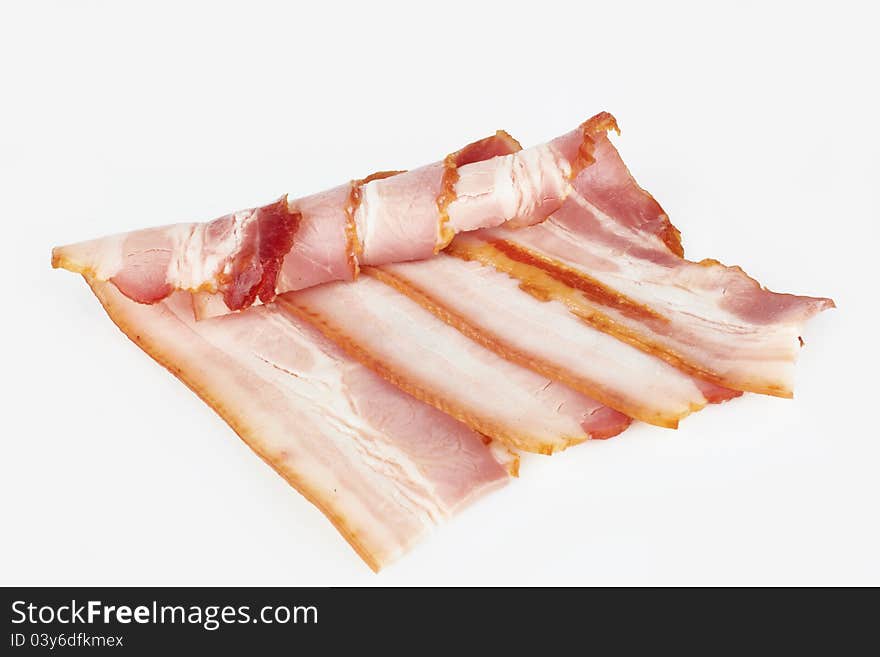 Tasty sliced pork bacon on white background