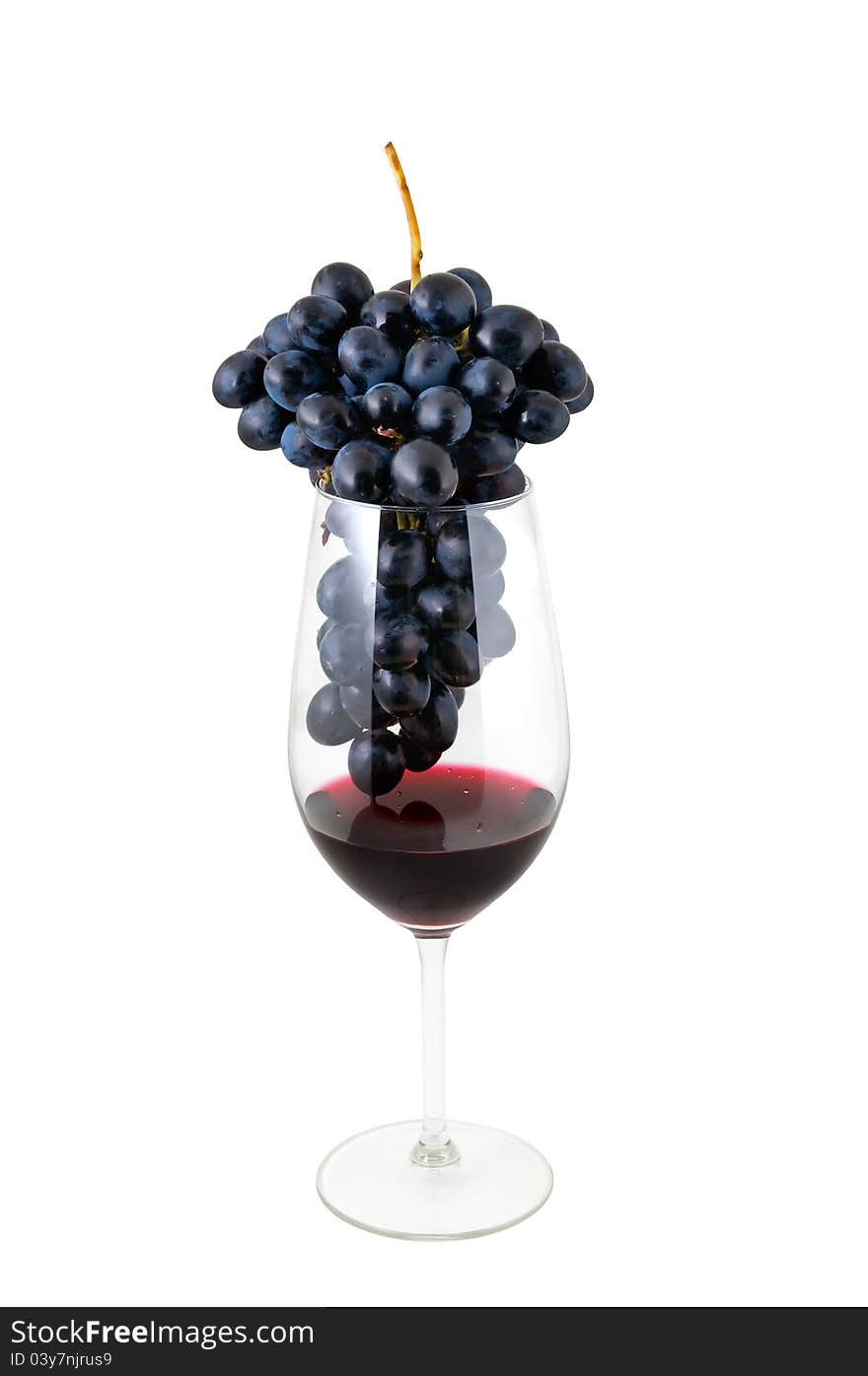 Bunch of a grape in a wineglass with wine