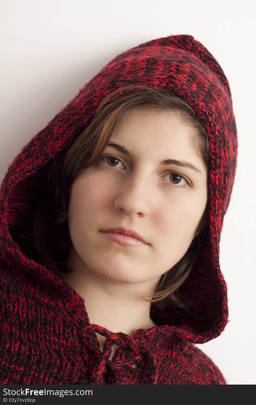 Beautiful girl in a red sweater with hood