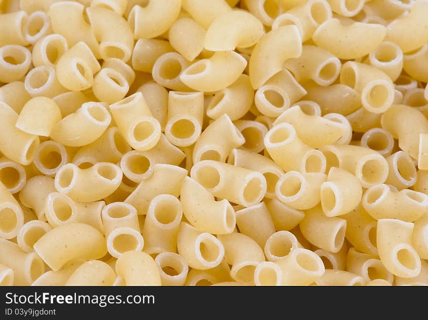 Background of uncooked small pasta horns