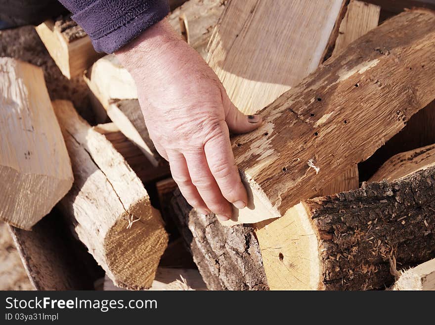 Winter time and snapshot over the hand of a worker over some wood pieces. Winter time and snapshot over the hand of a worker over some wood pieces