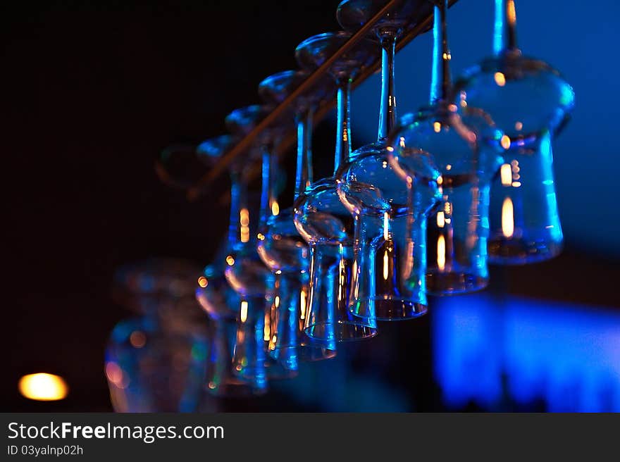 Cocktail glasses over the bar on a blue background