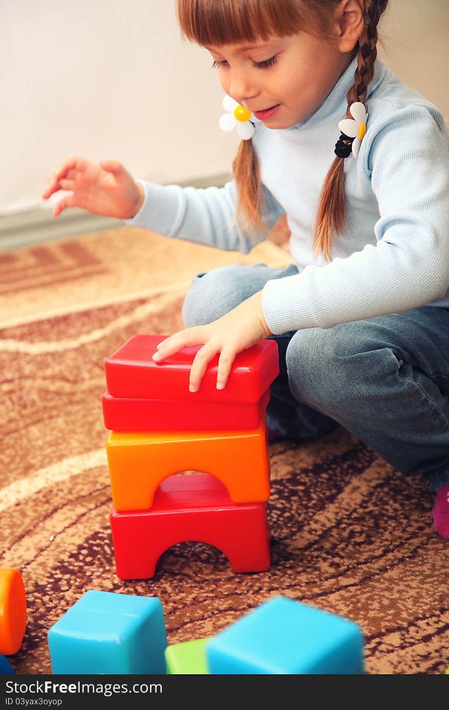 Little Girl Playing With Cubes