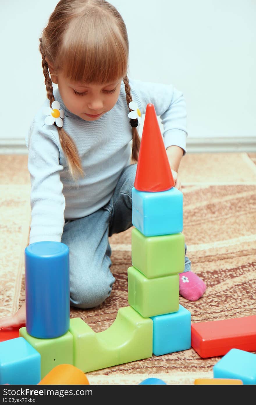 Little girl playing with cubes