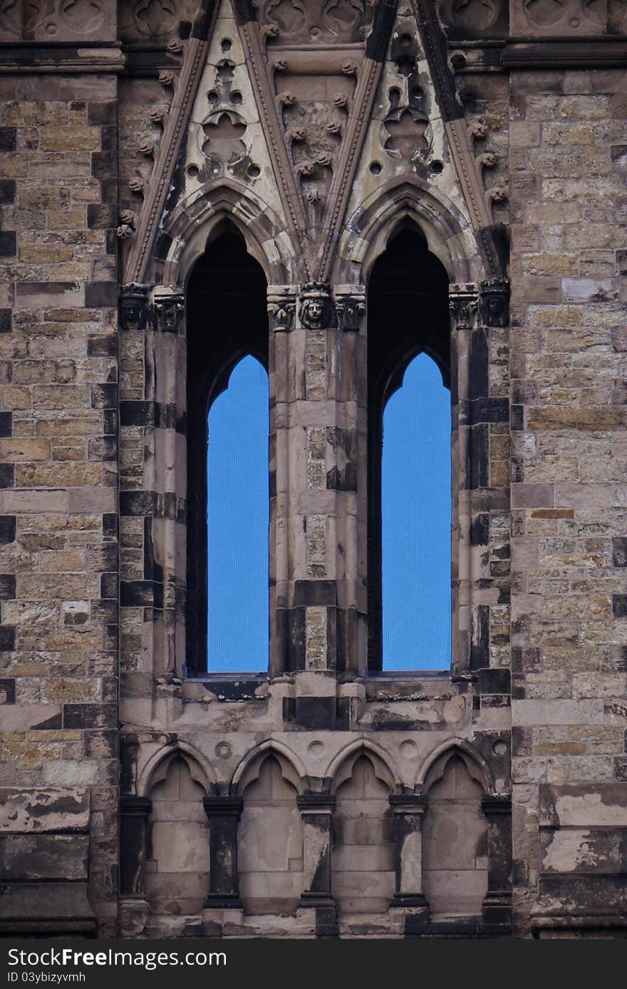 Close up of 18th century church spire window and its windows revealing blue skies. Close up of 18th century church spire window and its windows revealing blue skies.
