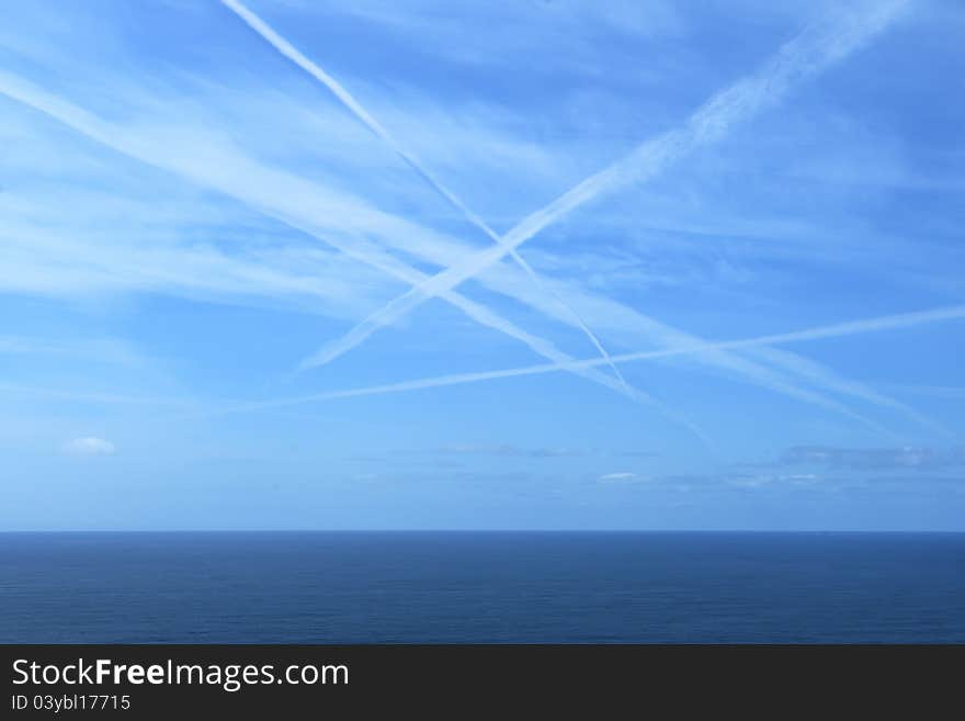 Plane marks on the sky over the sea