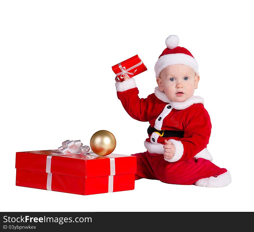 Little baby boy wearing Santa's costume sitting and holding a box with christmas 
presents. Little baby boy wearing Santa's costume sitting and holding a box with christmas 
presents