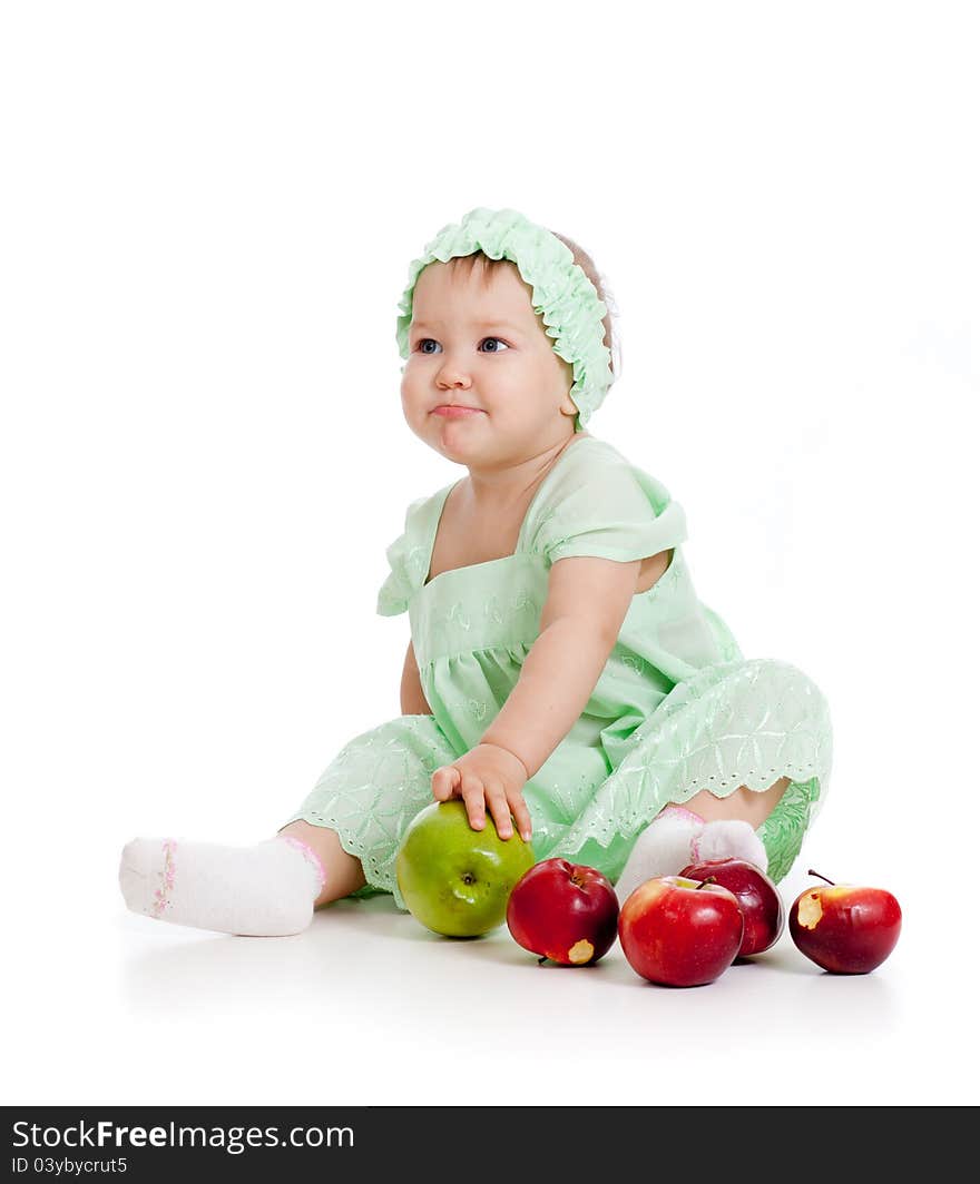 Baby girl with healthy food apples