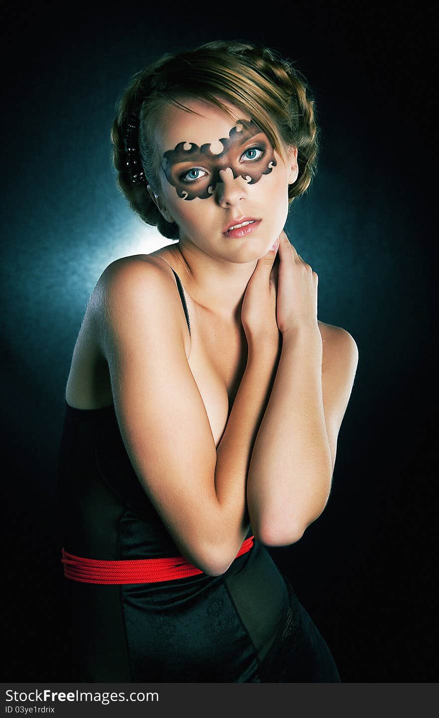 Festival - beautiful girl in party mask posing in studio. Festival - beautiful girl in party mask posing in studio