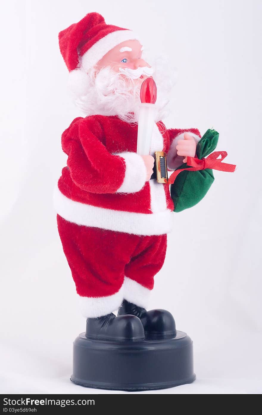 Santa Claus doll with red light and green bag.