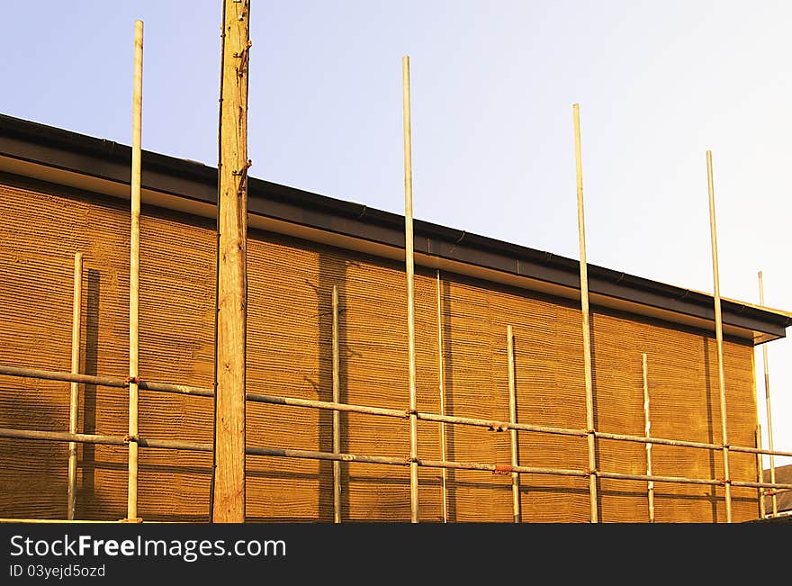 Simple scaffolding setup on a domestic property being rendered with plaster. Perspective corrected. Copy space. Simple scaffolding setup on a domestic property being rendered with plaster. Perspective corrected. Copy space.