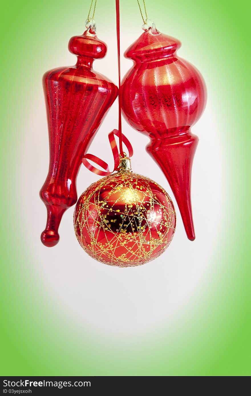 Red glass balls and cones on white with green vignette. Red glass balls and cones on white with green vignette.