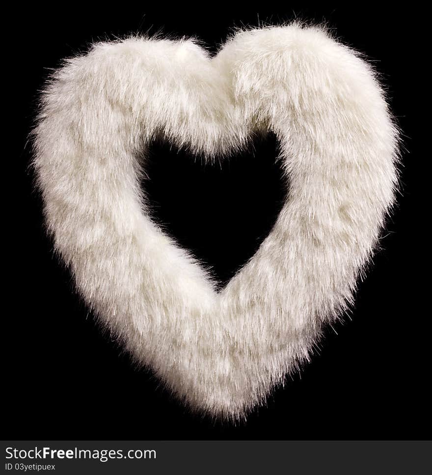 Furry white heart isolated on black