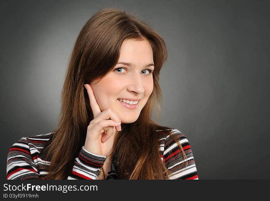 Portrait of the attractive woman on a grey background. Portrait of the attractive woman on a grey background