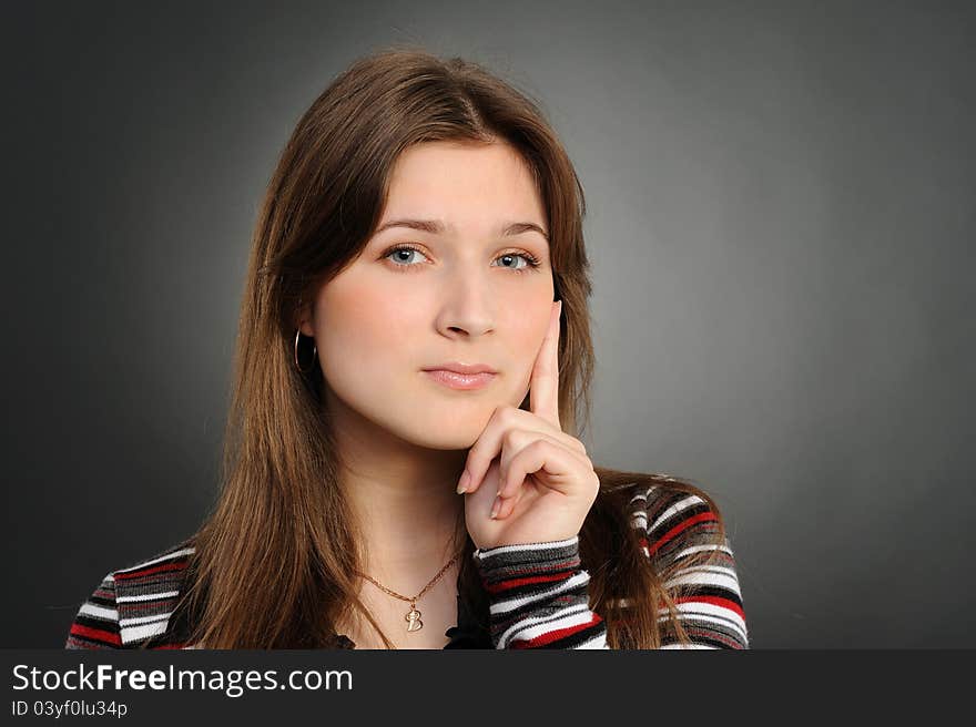 Woman thinking, a grey background. Woman thinking, a grey background