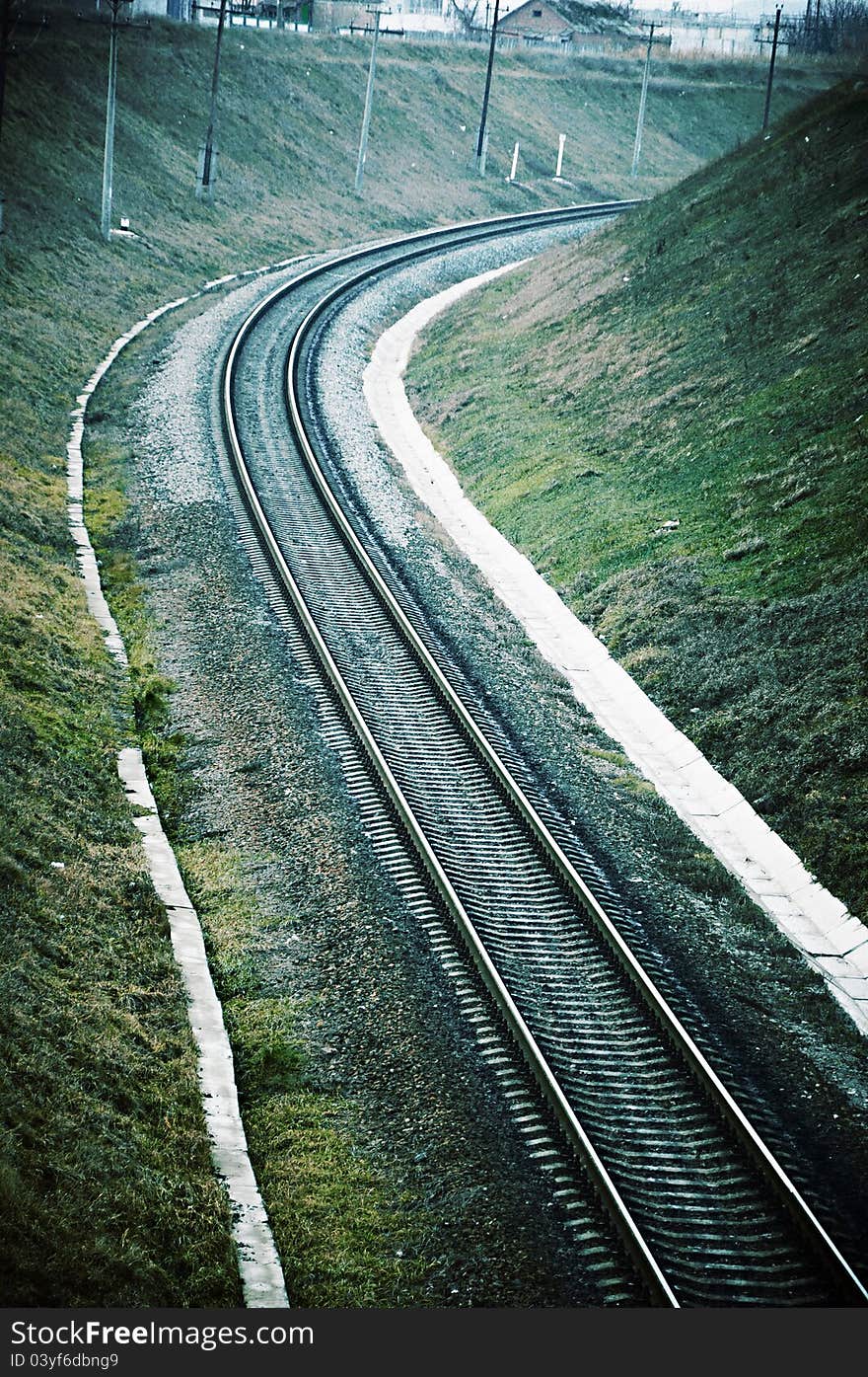 Railway bed leaving for turn in a surrounding of hills. Railway bed leaving for turn in a surrounding of hills