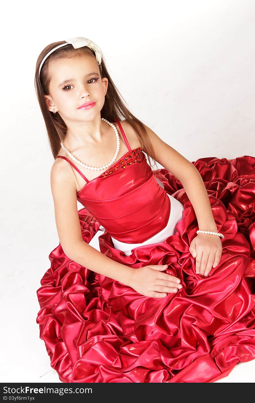 Beautiful little girl in red evening dress