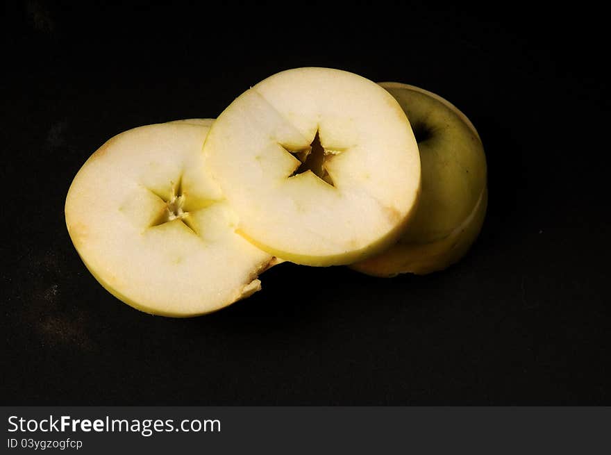 Closeup with sliced apple studio  on black background. Closeup with sliced apple studio  on black background