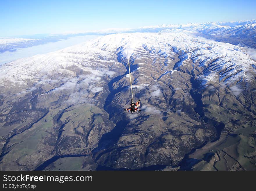 Skydive over snow mountain