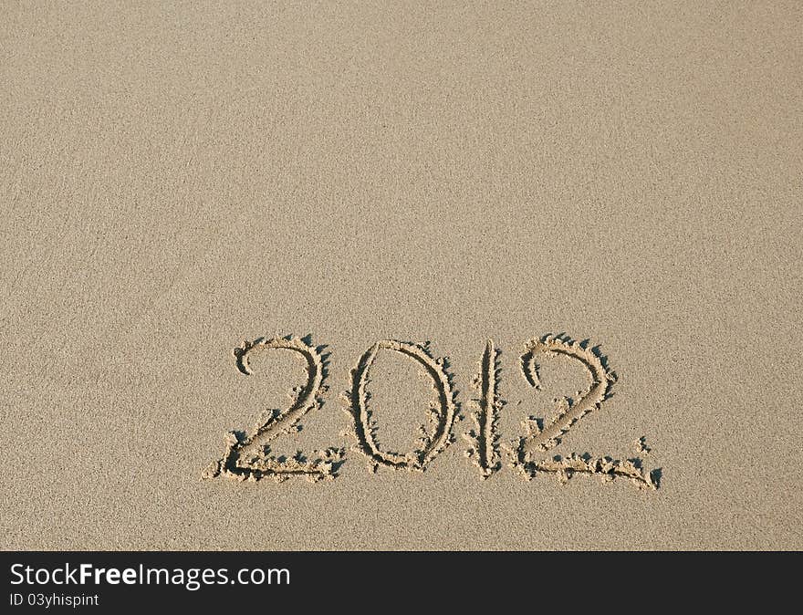 2012 inscription on the sand . New year.