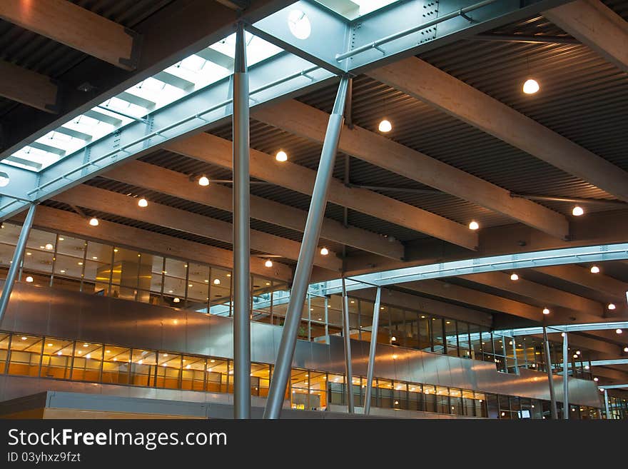 Inside a modern international airport terminal made of steel, glass and wood