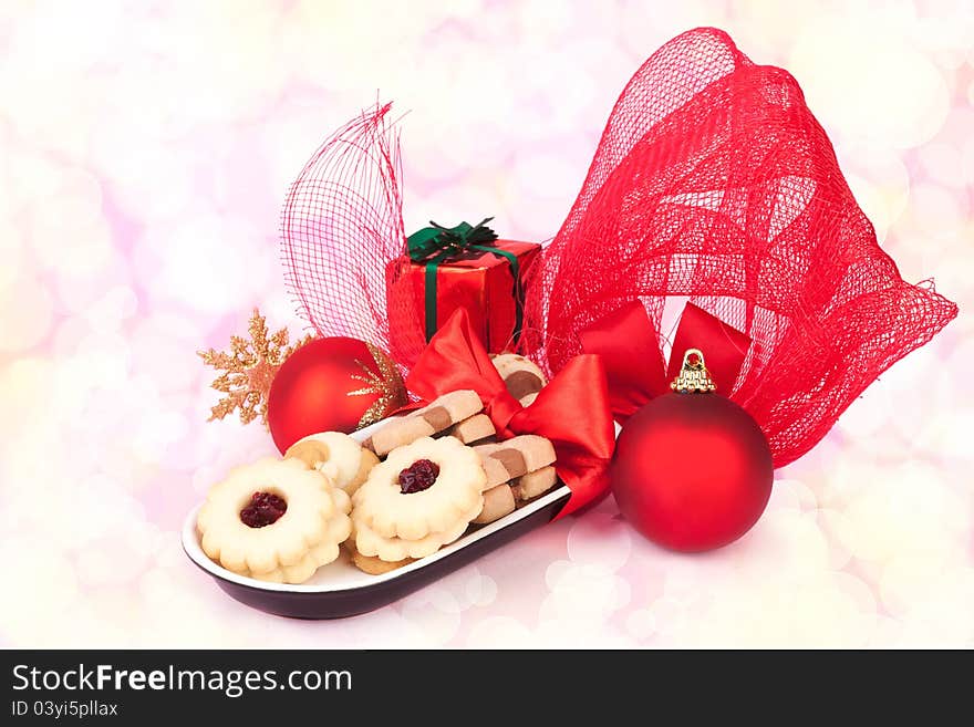 Beautiful christmas still life with biscuits, red xmas balls, gift and various decoration. Bokeh christmas food and decoration background. Beautiful christmas still life with biscuits, red xmas balls, gift and various decoration. Bokeh christmas food and decoration background.