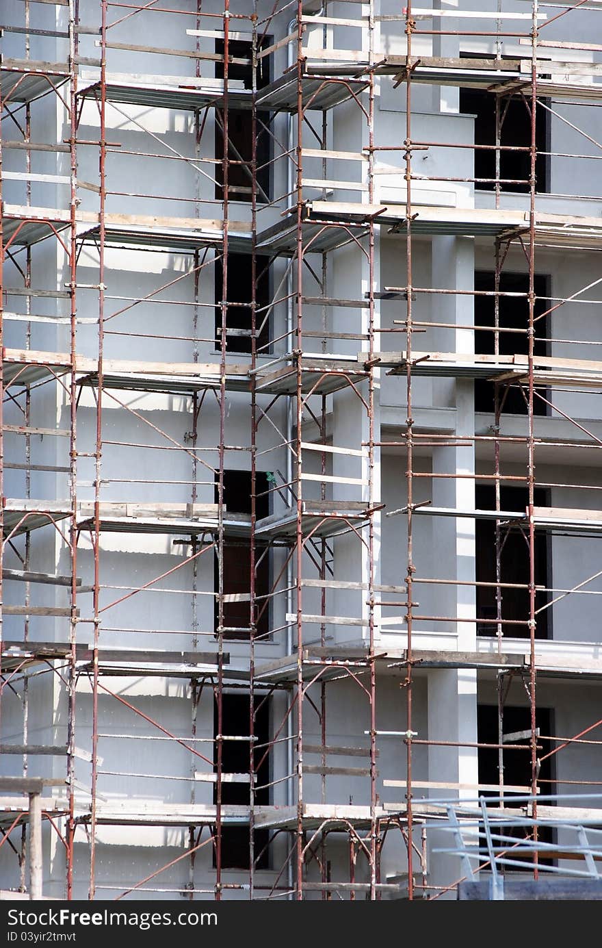 Building under construction with rusted scaffold