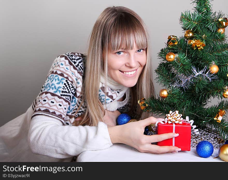 Beautiful woman gives a Christmas gift. Beautiful woman gives a Christmas gift