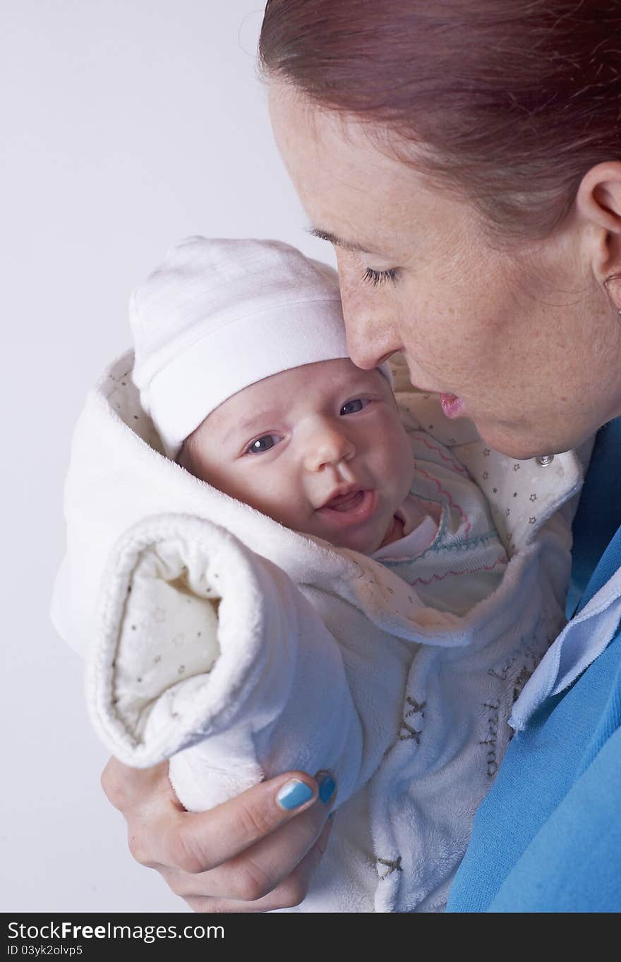 Middle aged women with her cute newborn female baby laughing with her eyes wide open, image taken as black and white with blur around the focus in the middle, less contrast. Middle aged women with her cute newborn female baby laughing with her eyes wide open, image taken as black and white with blur around the focus in the middle, less contrast