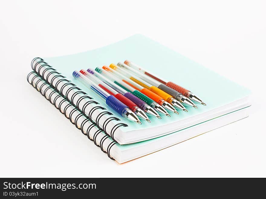 Notebooks and pens on a white background