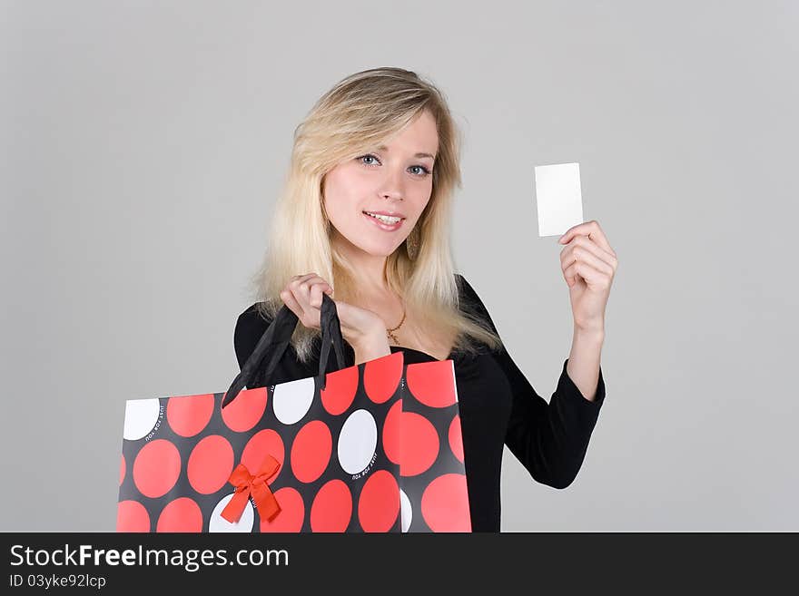 Young girl with bag shows a blank plastic card