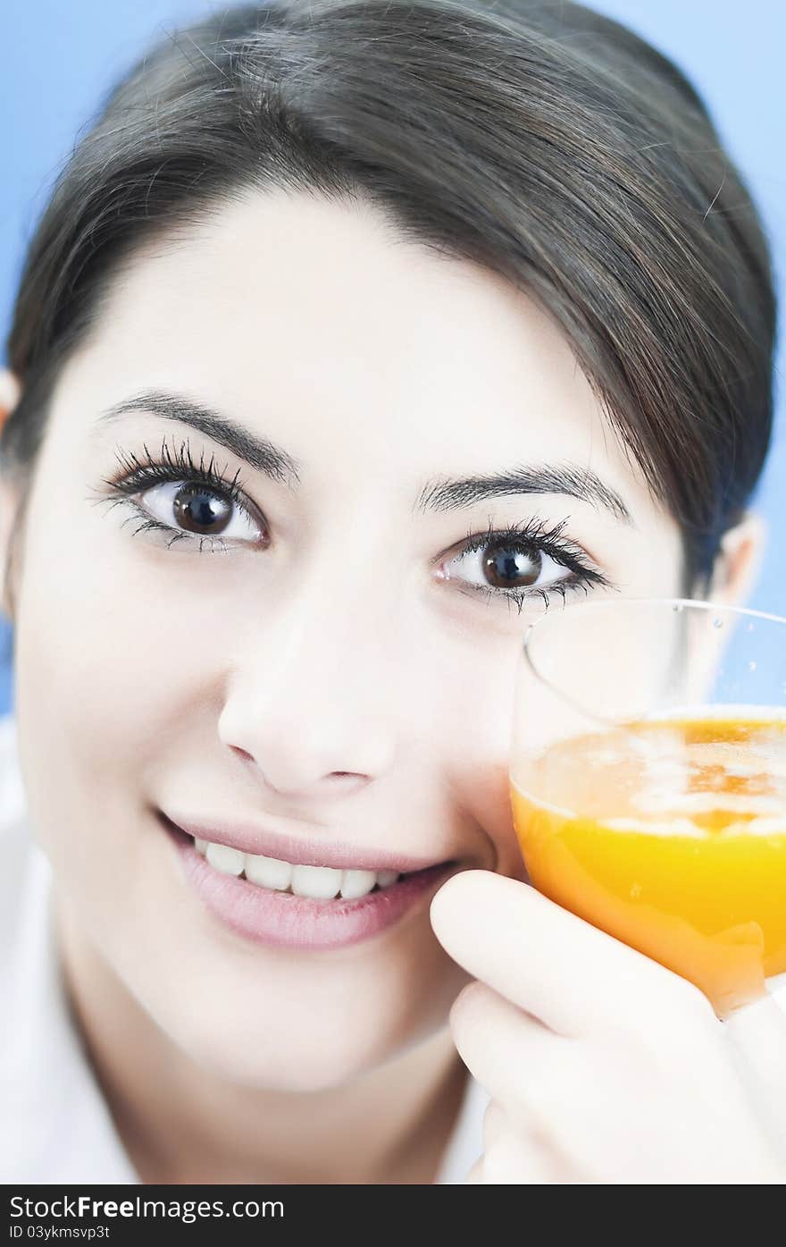 Portrait of a woman relaxing with an orange juice in lunch break before starting work. Portrait of a woman relaxing with an orange juice in lunch break before starting work