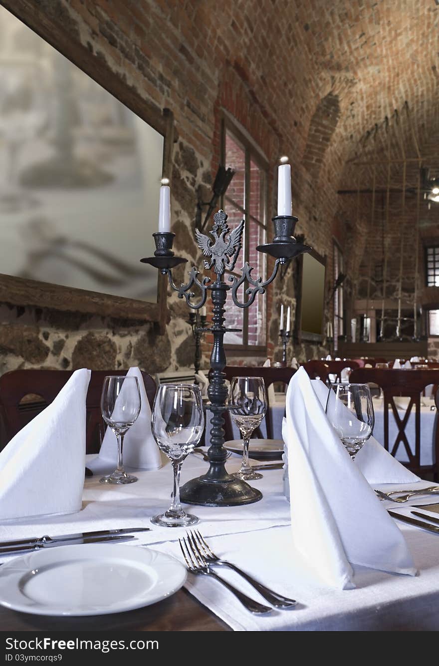 Served table with an ancient candlestick. Served table with an ancient candlestick