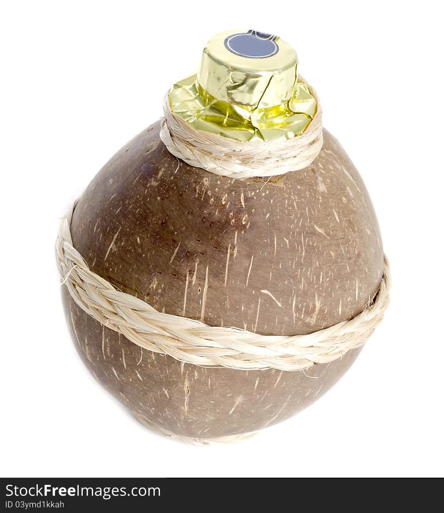 A coconut container containing coconut liqueur isolated on white.