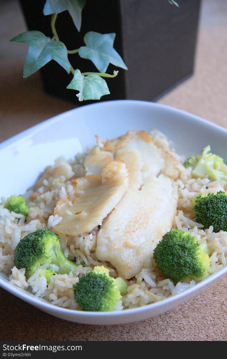 A bowl of fried rice with seafood and broccoli on table for lunch or dinner. A bowl of fried rice with seafood and broccoli on table for lunch or dinner