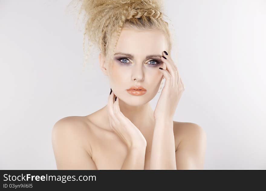 Young pretty woman with beautiful blond hairs and multicolor makeup isolated on white background