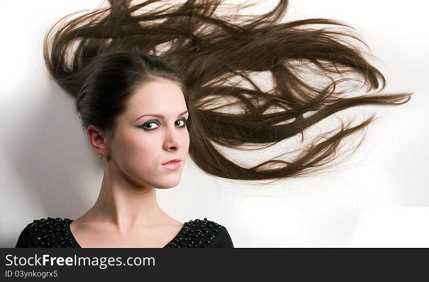 Close-up portrait of girl with beautiful fresh face and gorgeous long hair on a white background. Close-up portrait of girl with beautiful fresh face and gorgeous long hair on a white background