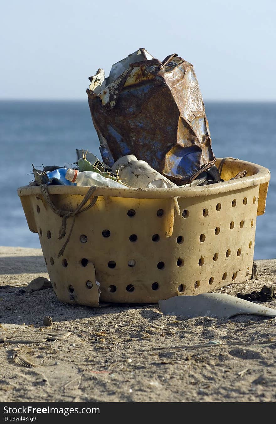 Garbage collected in a plastic basket. Garbage collected in a plastic basket