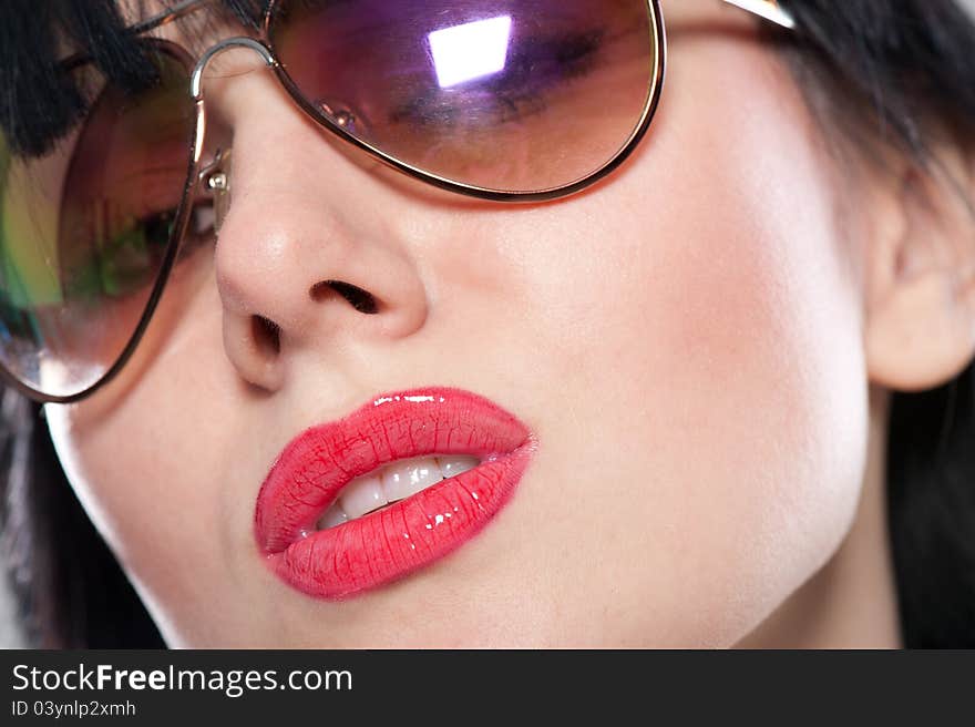 Close-up portrait of sensual and tender woman's face wearing sunglasses. Close-up portrait of sensual and tender woman's face wearing sunglasses