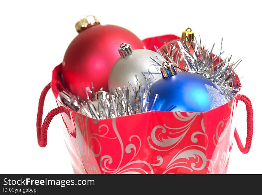 Christmas balls in gift bag isolated on white