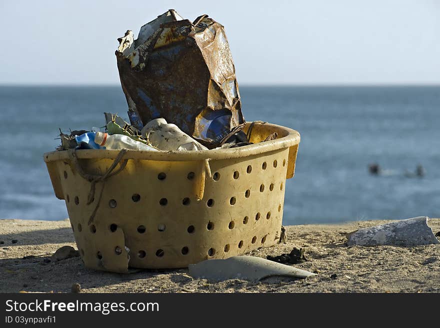 Garbage collected in a plastic basket. Garbage collected in a plastic basket