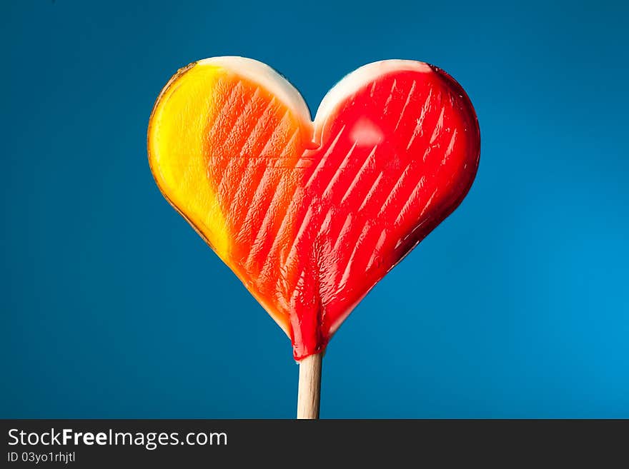 Candy heart on blue background