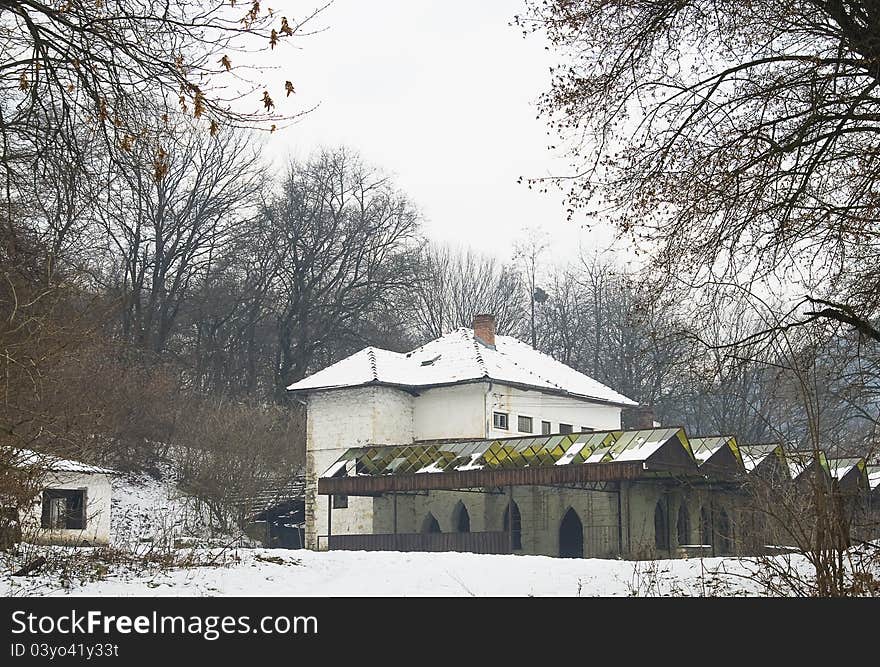 Winter scene of an abandoned rest house, at the fringe of a forest.