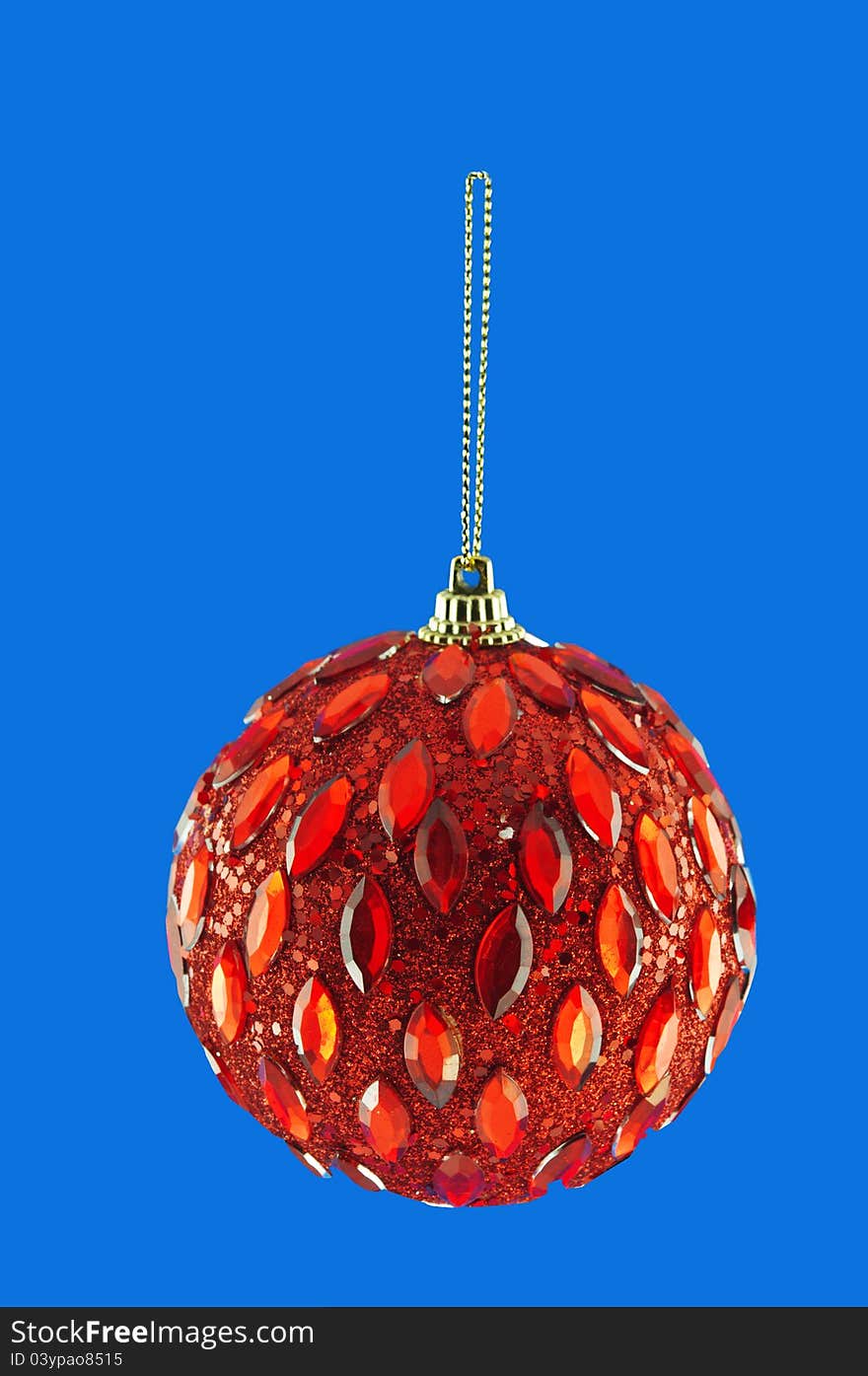 Red ball, Christmas decorations hanging on a golden thread against the blue background