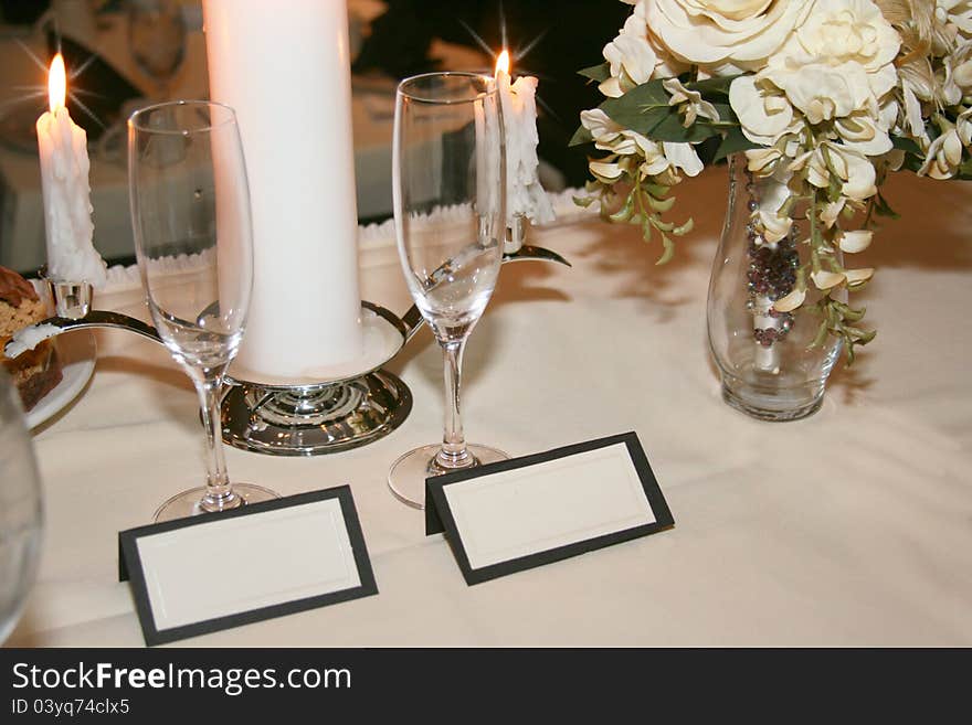 Blank fill-in placecards for couple with linens, champagne glasses, candles and bouquet. Blank fill-in placecards for couple with linens, champagne glasses, candles and bouquet